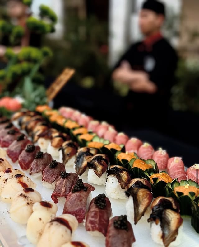 Live sushi station at a New York wedding event with chef preparing fresh rolls