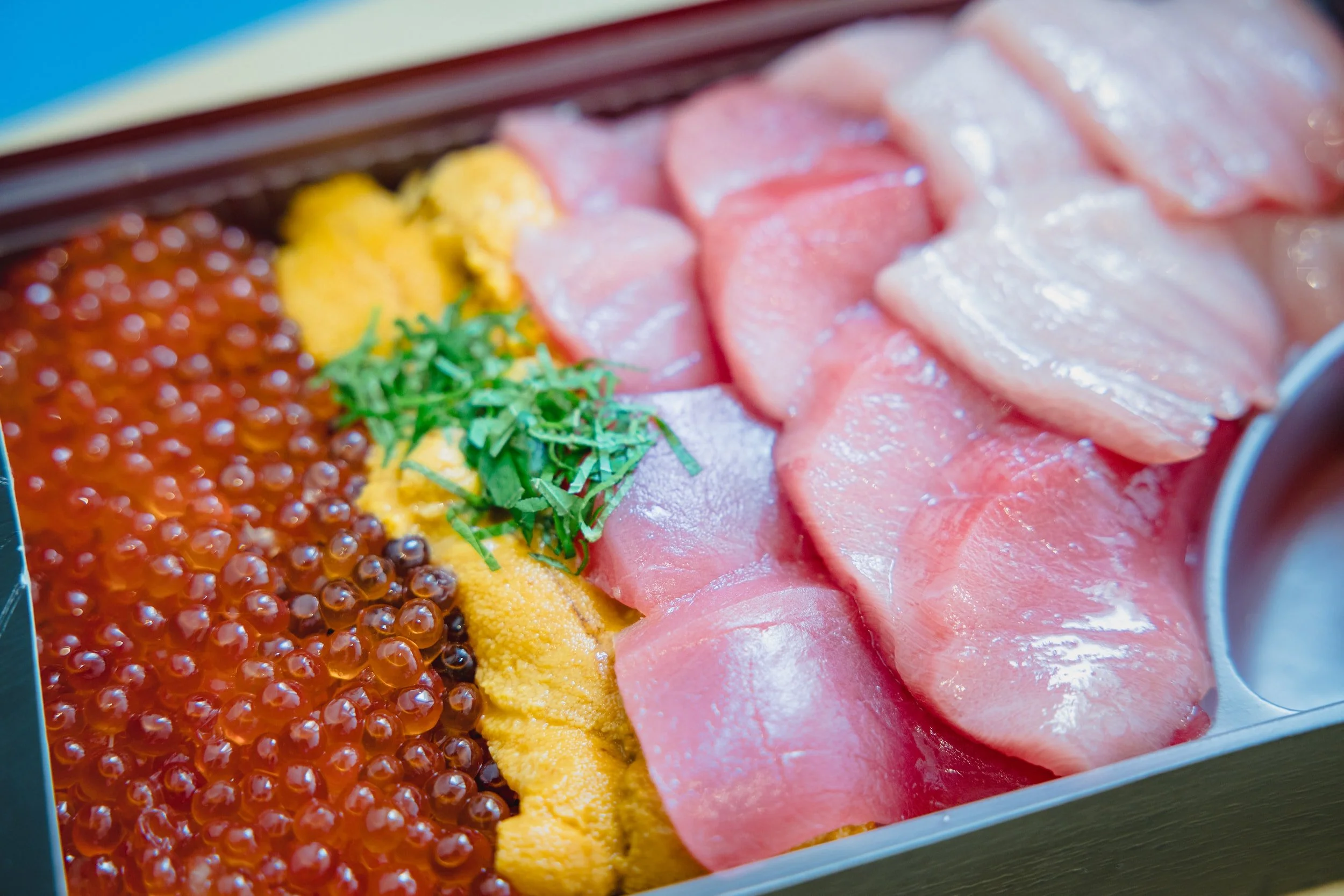 Premium sashimi box with ikura salmon roe and uni sea urchin for luxury catering in NYC