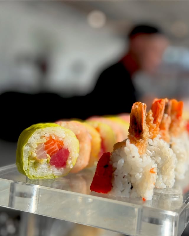 Sushi chef preparing fresh rainbow rolls at private NYC catering event