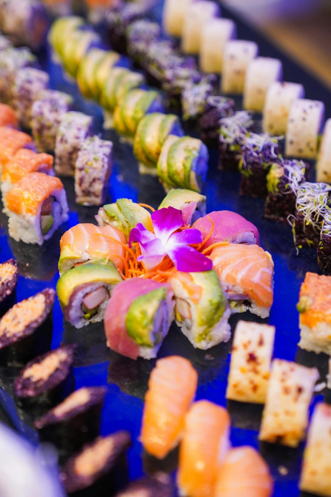 Stunning sushi display with blue ambient lighting at an upscale private party in NYC